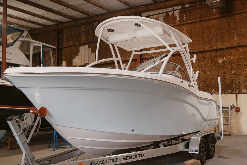 2026 Sea Fox 228 Traveler boat on trailer in indoor storage facility.