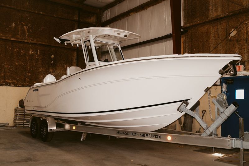 2026 Sea Fox 268 Commander boat on trailer in indoor storage.