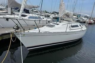 1986 Beneteau First 305 sailboat docked in a marina.