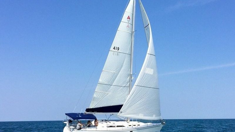Sailing yacht Catalina 400 MkII 1995 gliding on open sea under clear blue sky.