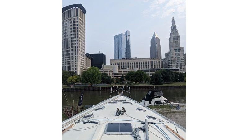 Jeanneau Sun Odyssey 45.2 sailboat docked with city skyline in the background.