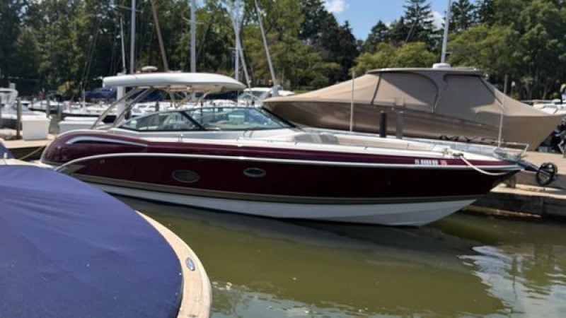 A 2014 Formula 350 Crossover Bowrider is docked in the water, surrounded by other boats.