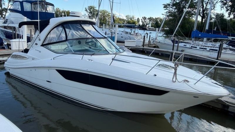 2015 Sea Ray Sundancer 330 yacht docked at marina, surrounded by other boats.