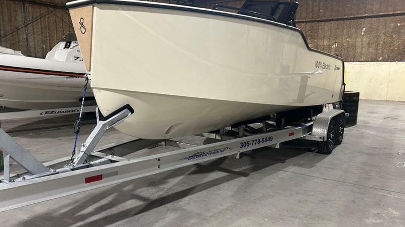 2024 X Shore 1 electric boat on trailer in indoor storage facility.