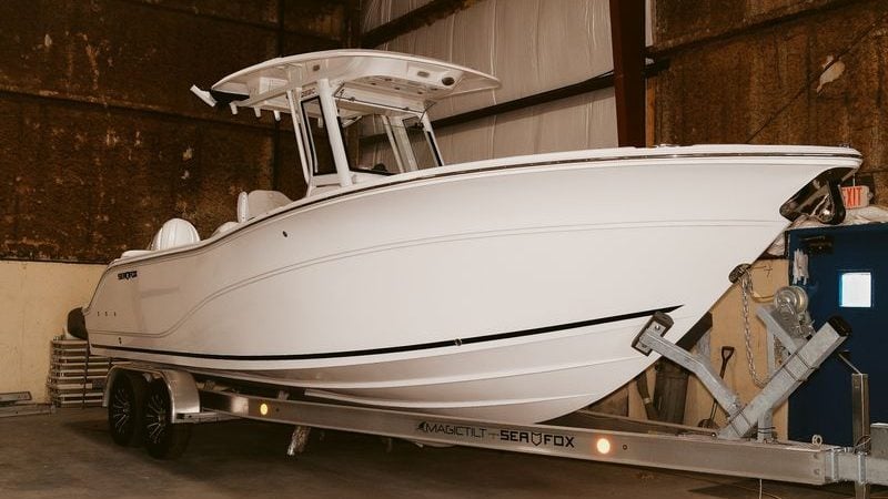 2026 Sea Fox 268 Commander boat on trailer in indoor storage.